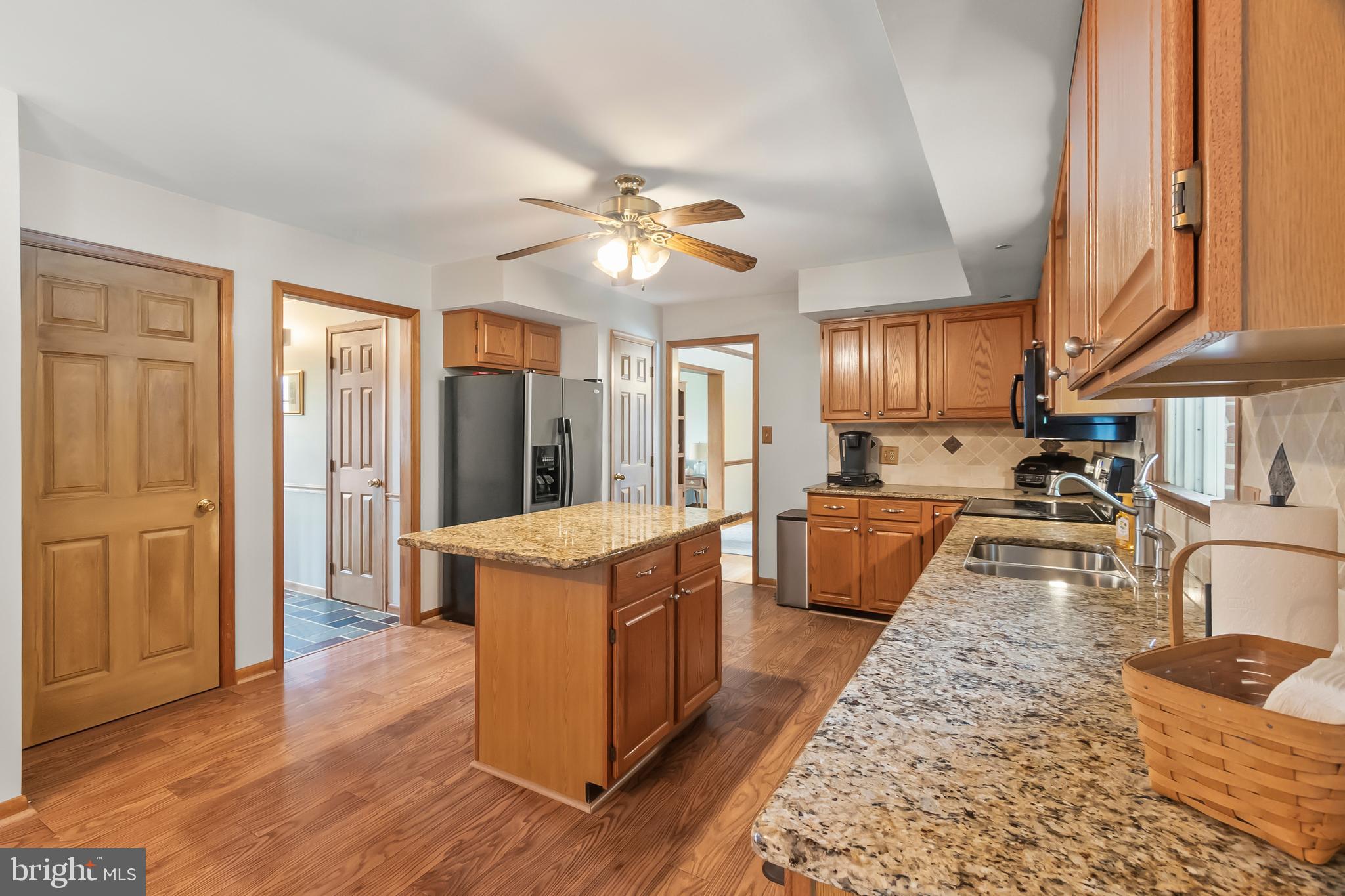8 Wortham Court Bear, DE 19701 - Photo 20 of 71 a kitchen with stainless steel appliances granite countertop wooden floors and white walls