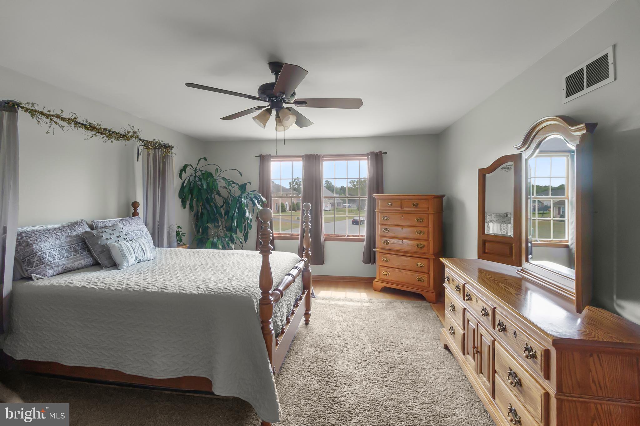 8 Wortham Court Bear, DE 19701 - Photo 32 of 71 a bedroom with a bed a flat screen tv and a large window