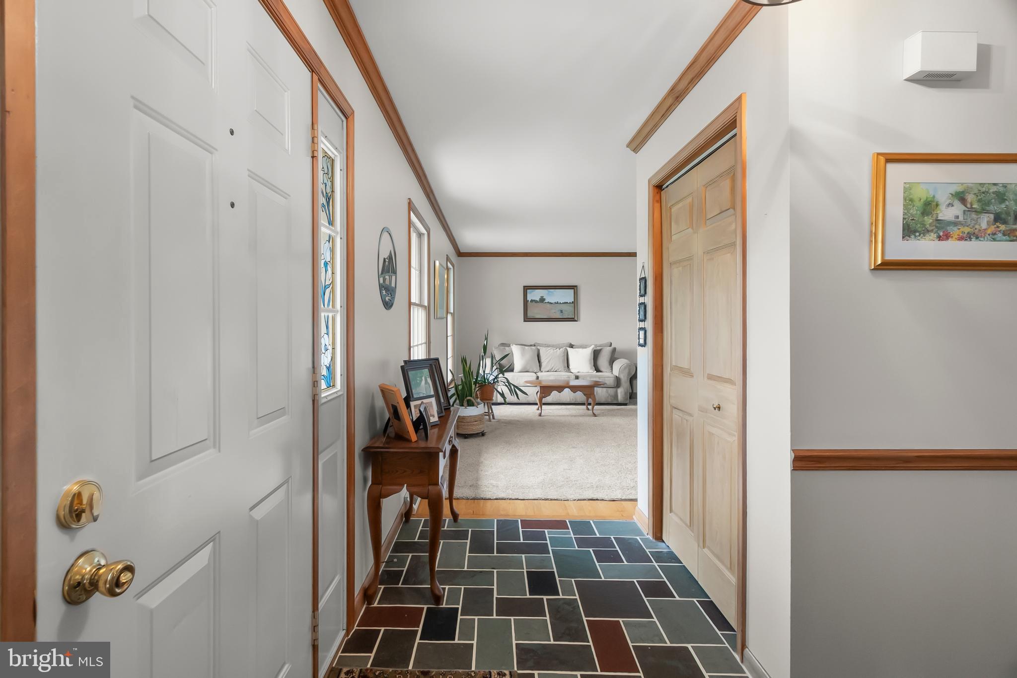 8 Wortham Court Bear, DE 19701 - Photo 4 of 71 a hallway with a couch and a dining table next to a window