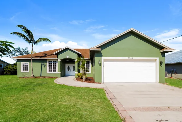 a front view of a house with a yard and garage