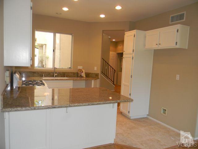11525 Treeview Court Moorpark, CA 93021 - Photo 5 of 17 a kitchen with stainless steel appliances granite countertop a sink a stove and a refrigerator