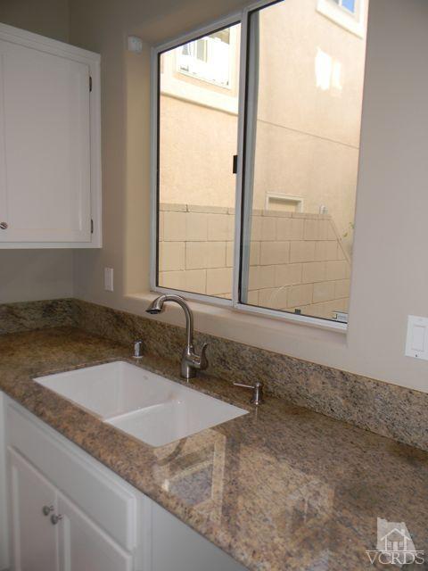 11525 Treeview Court Moorpark, CA 93021 - Photo 7 of 17 a bathroom with a granite countertop sink and a window