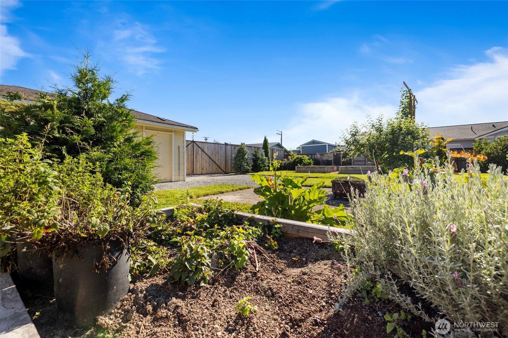 415 Sterling Street Sedro-Woolley, WA 98284 - Photo 34 of 38 a view of a garden with plants and a lake view