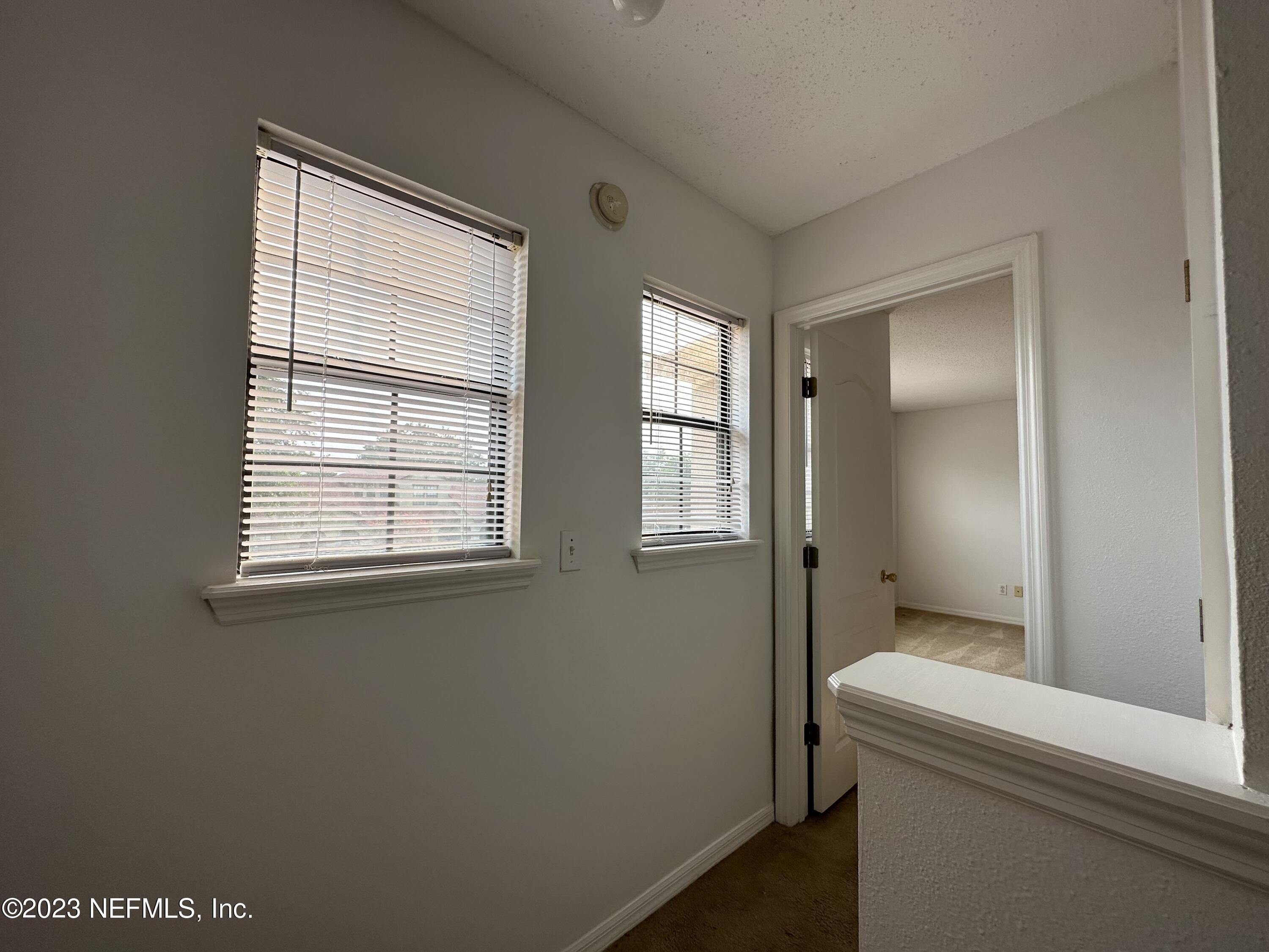 744 Ginger Mill Drive St. Johns, FL 32259 - Photo 13 of 28 a bathroom with a bathtub and a window