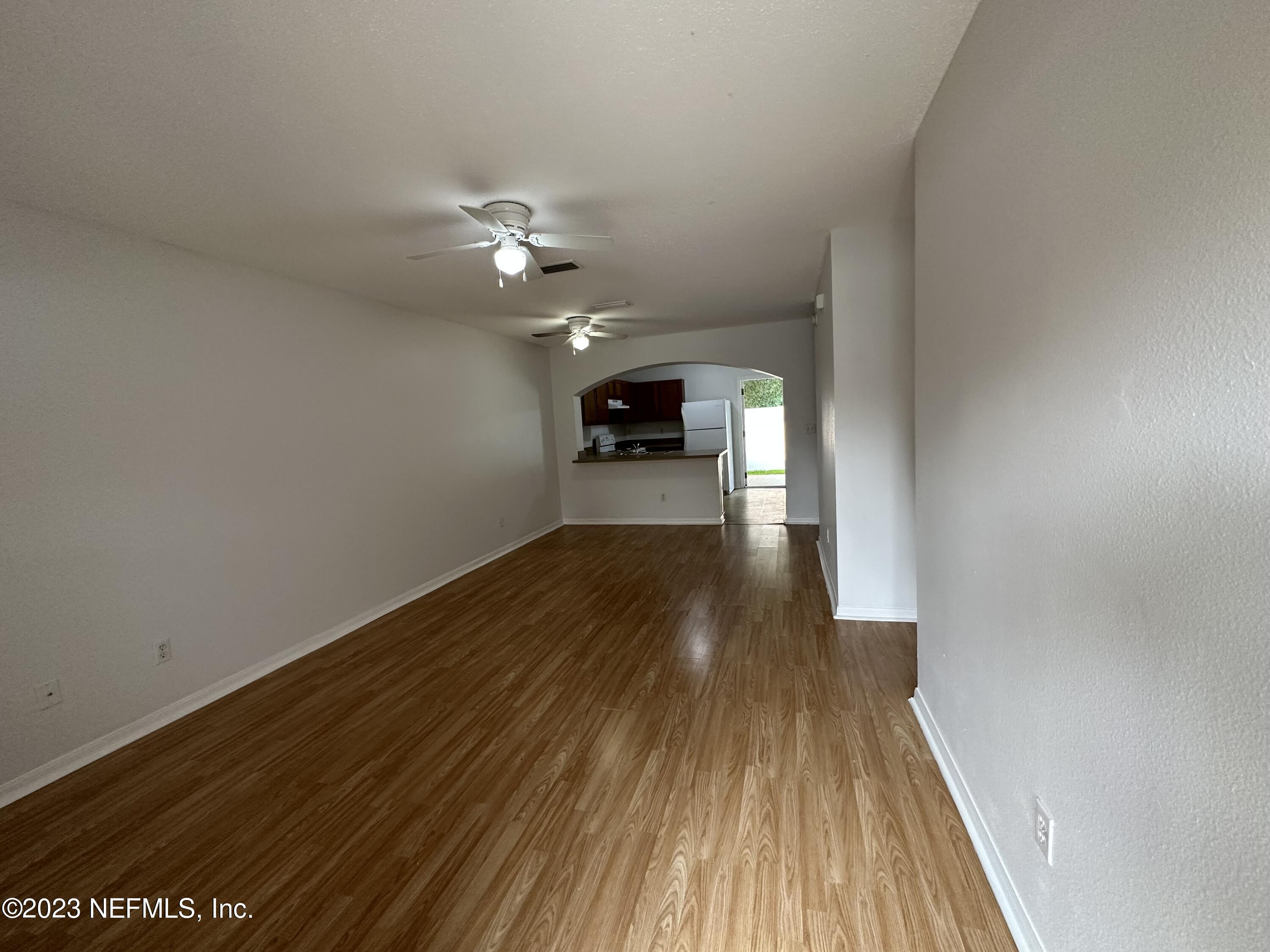 744 Ginger Mill Drive St. Johns, FL 32259 - Photo 6 of 28 wooden floor in an empty room with a window