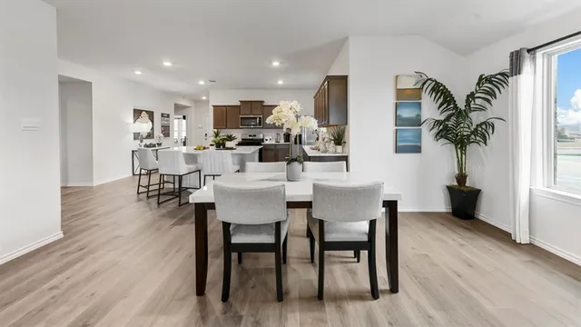a view of a dining room with furniture and window