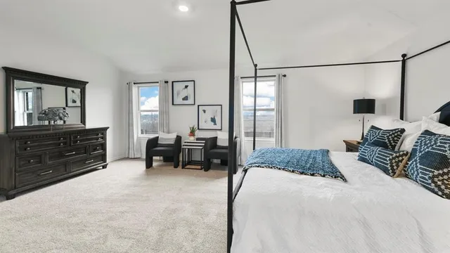 a bedroom with a bed window and a dresser