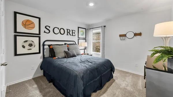 a bedroom with a bed and painting on the wall