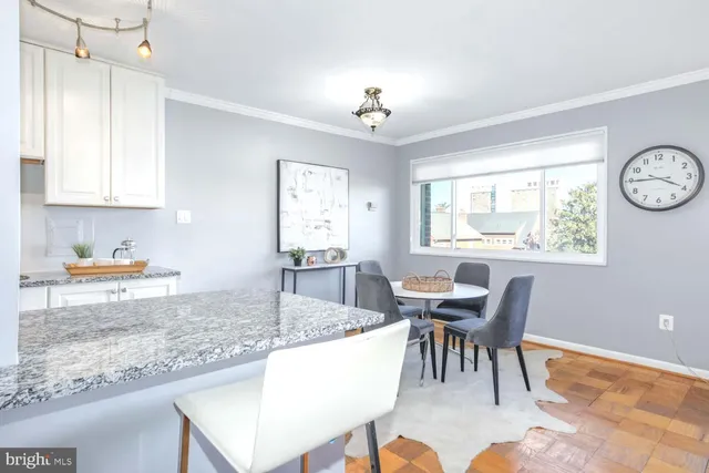 a view of a dining room with furniture and a chandelier