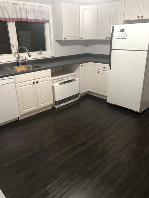 144 Spring Street Cambridge, MA 02141 - Photo 2 of 12 a kitchen with granite countertop a sink and a stove