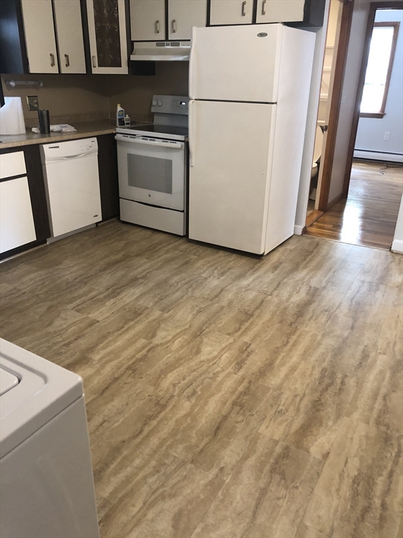 144 Spring Street Cambridge, MA 02141 - Photo 4 of 12 a white refrigerator freezer sitting inside of a kitchen
