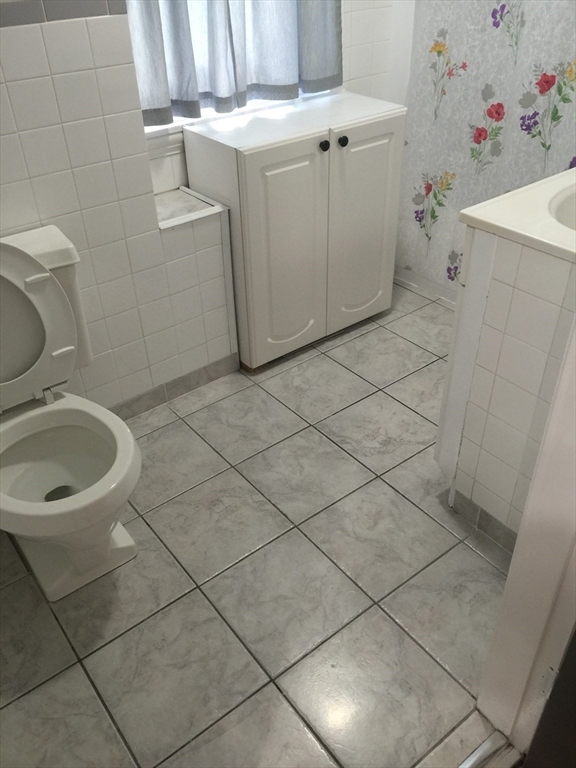 144 Spring Street Cambridge, MA 02141 - Photo 5 of 12 a bathroom with a sink and toilet