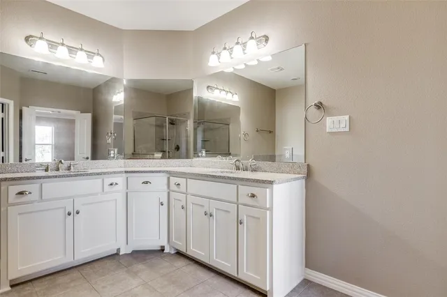 a bathroom with a double vanity sink and a mirror