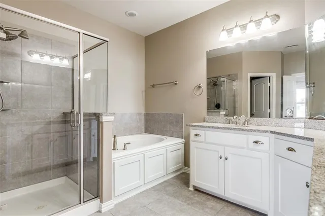 a bathroom with a shower sink and mirror