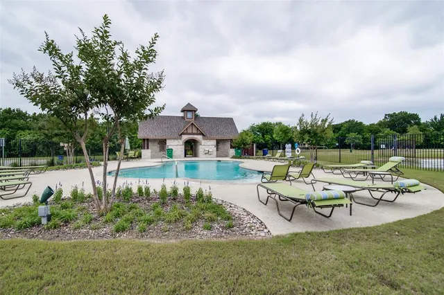 a view of a house with pool and a chairs