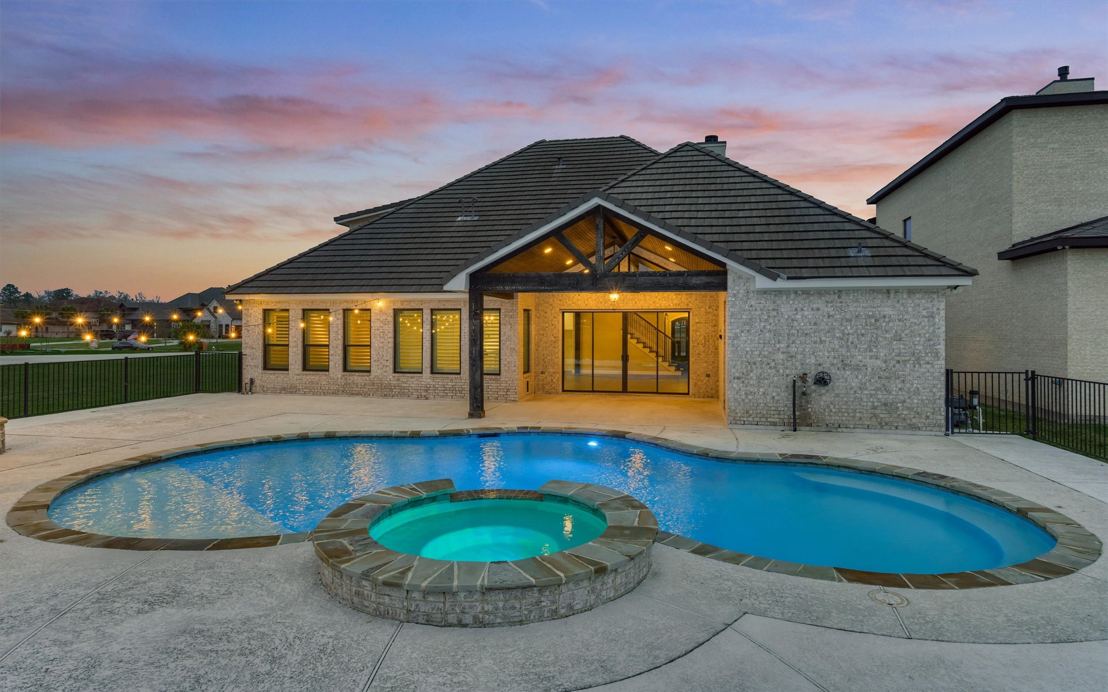11618 Renaissance Drive Montgomery, TX 77356 - Photo 41 of 49 The rear elevation shows the sparkling chloring pool with seating bench at the perimeter and changeable lighting for added ambiance.