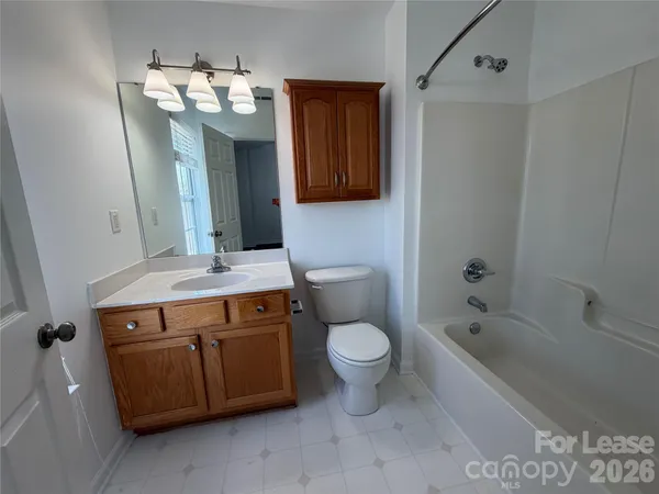 a bathroom with a sink a toilet and bathtub