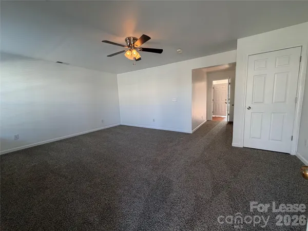 a view of a room with a ceiling fan