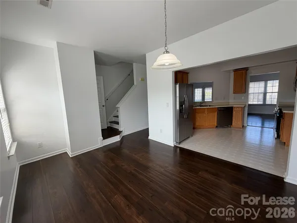 a view of a livingroom with wooden floor and a ceiling fan