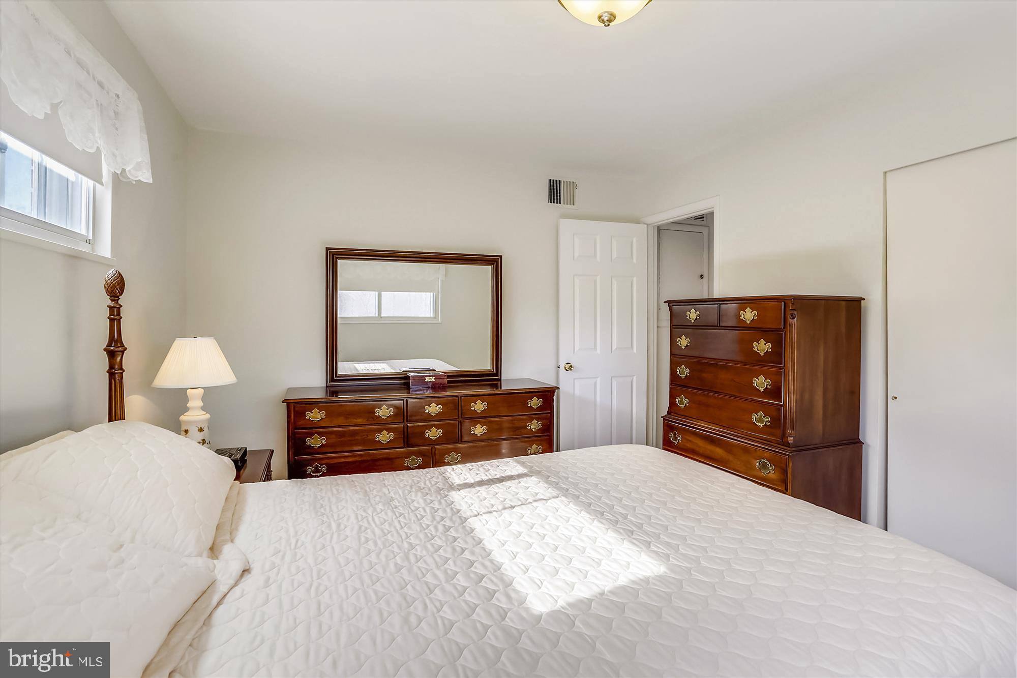 13005 Carney Street Silver Spring, MD 20906 - Photo 16 of 30 a bedroom with a bed and dresser with mirror