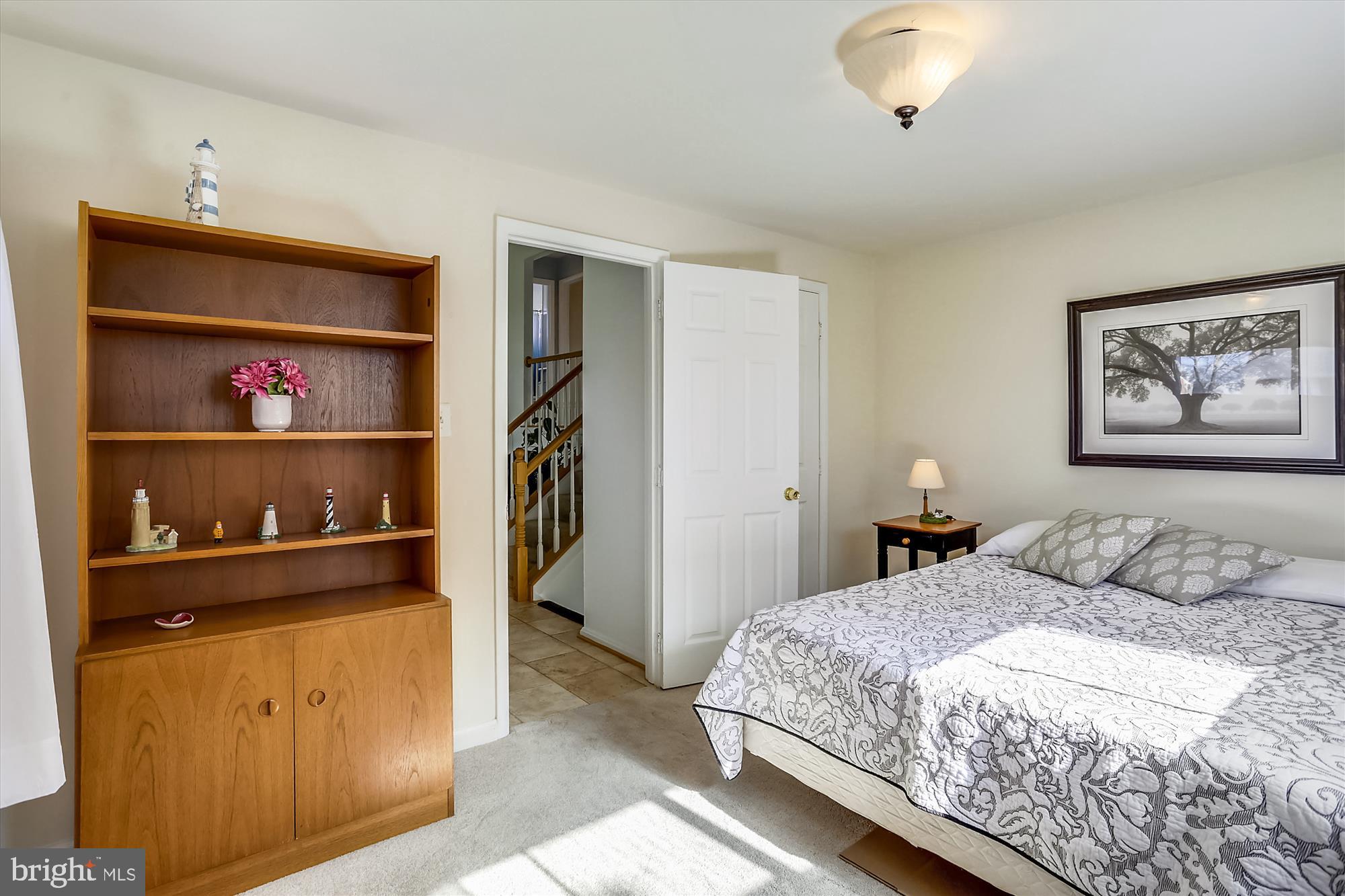 13005 Carney Street Silver Spring, MD 20906 - Photo 20 of 30 a bedroom with a bed and a book shelf