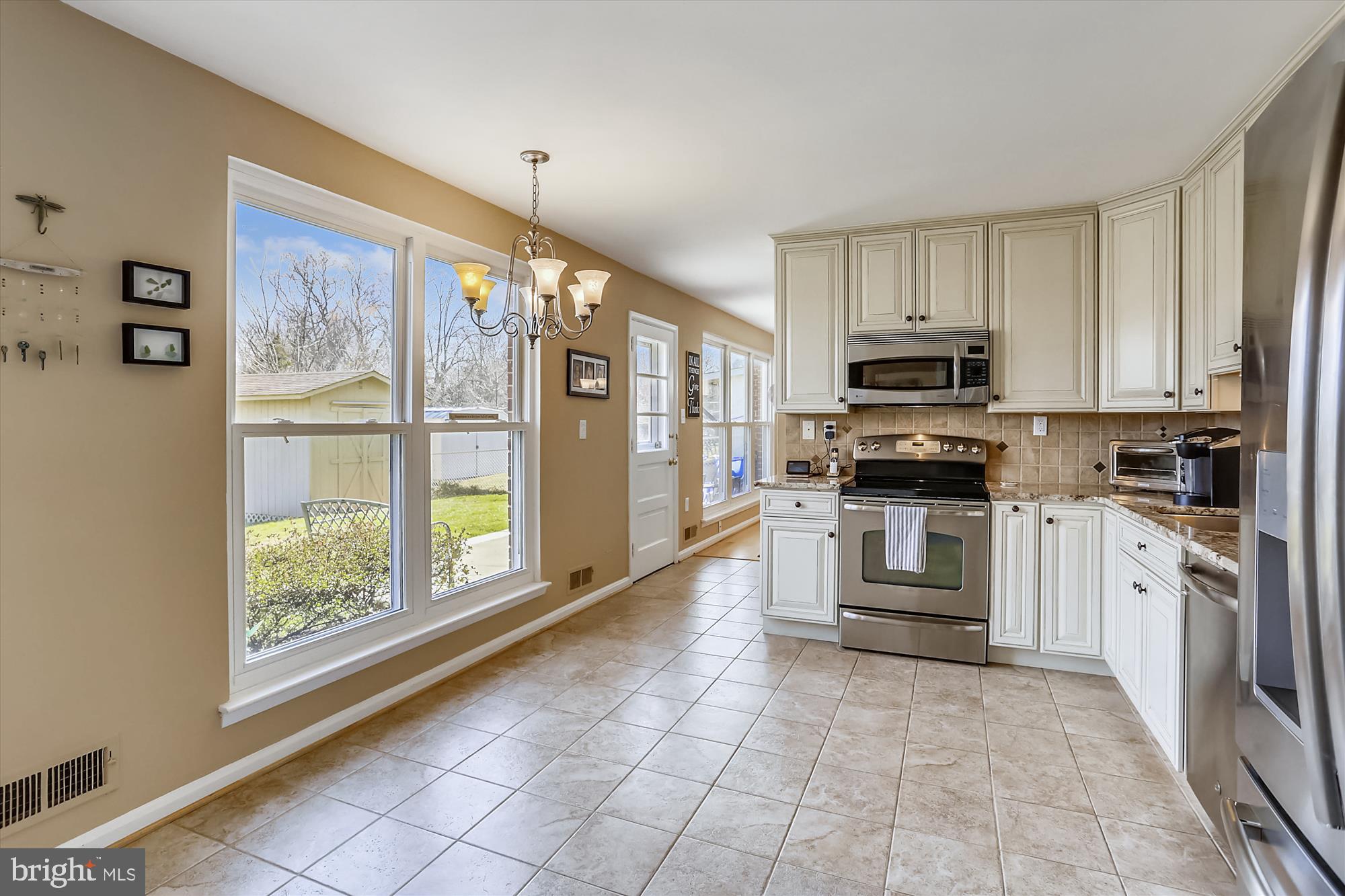 13005 Carney Street Silver Spring, MD 20906 - Photo 4 of 30 a kitchen with white cabinets and appliances