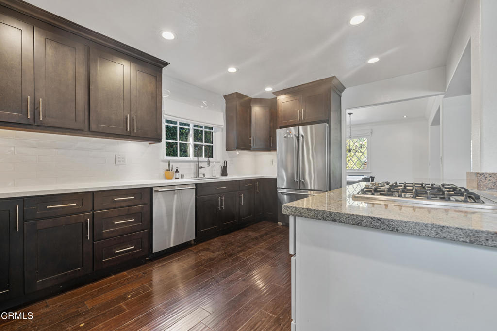 263 San Miguel Road Pasadena, CA 91105 - Photo 14 of 28 a kitchen with stainless steel appliances kitchen island granite countertop a stove a sink and a refrigerator