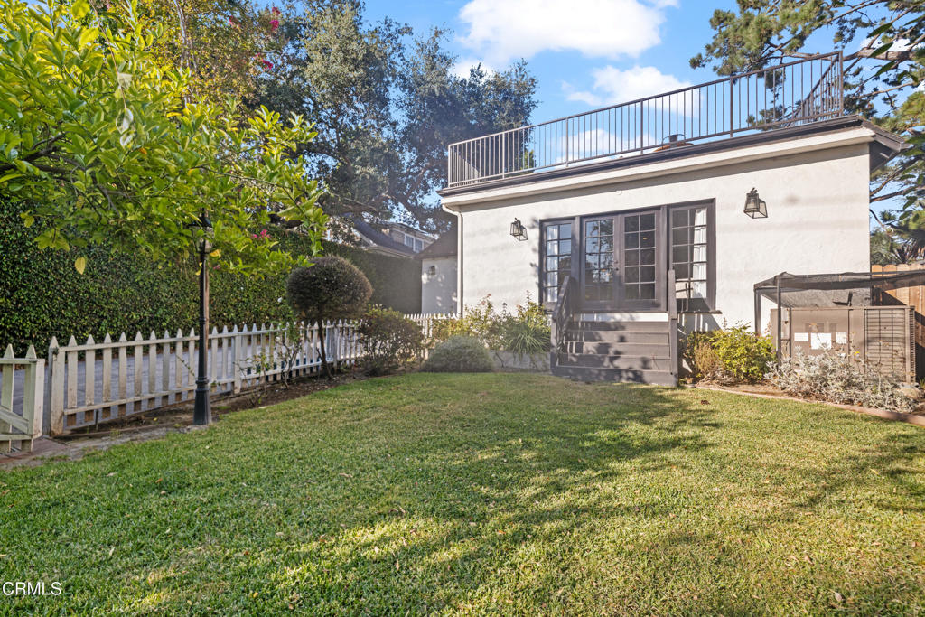 263 San Miguel Road Pasadena, CA 91105 - Photo 26 of 28 a view of a house with a yard and a large tree