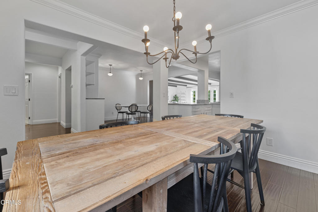 263 San Miguel Road Pasadena, CA 91105 - Photo 10 of 28 a room with kitchen island a chandelier and wooden floor