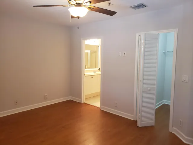 an empty room with a empty space and a ceiling fan