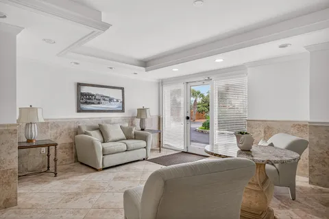 a view of a dining room with furniture and a chandelier