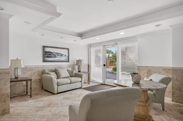 a view of a dining room with furniture and a chandelier
