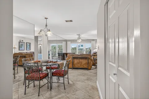 a kitchen with stainless steel appliances granite countertop a sink a refrigerator and a white cabinets
