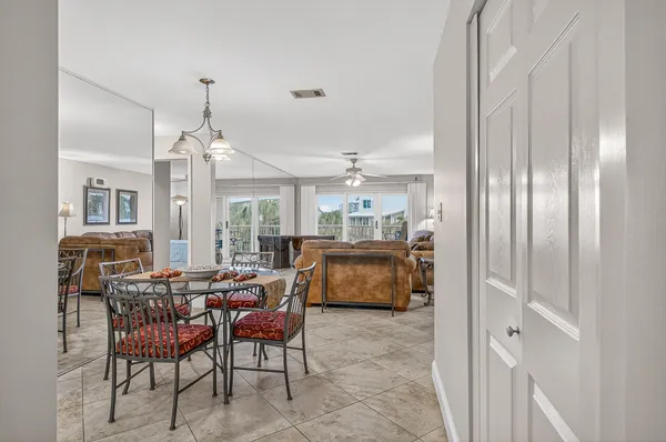 a kitchen with stainless steel appliances granite countertop a sink a refrigerator and a white cabinets