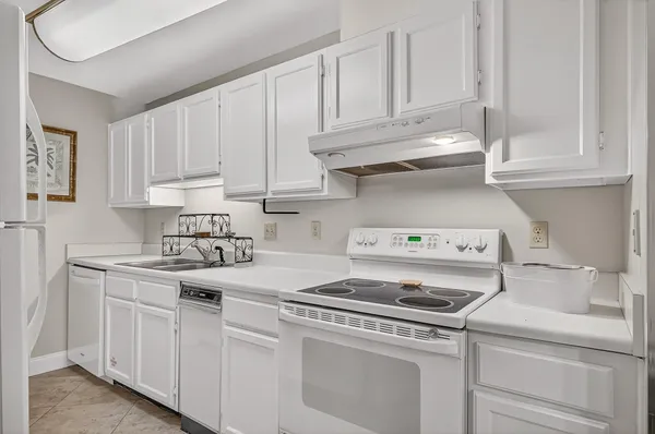 a dining room with a wooden table and chairs