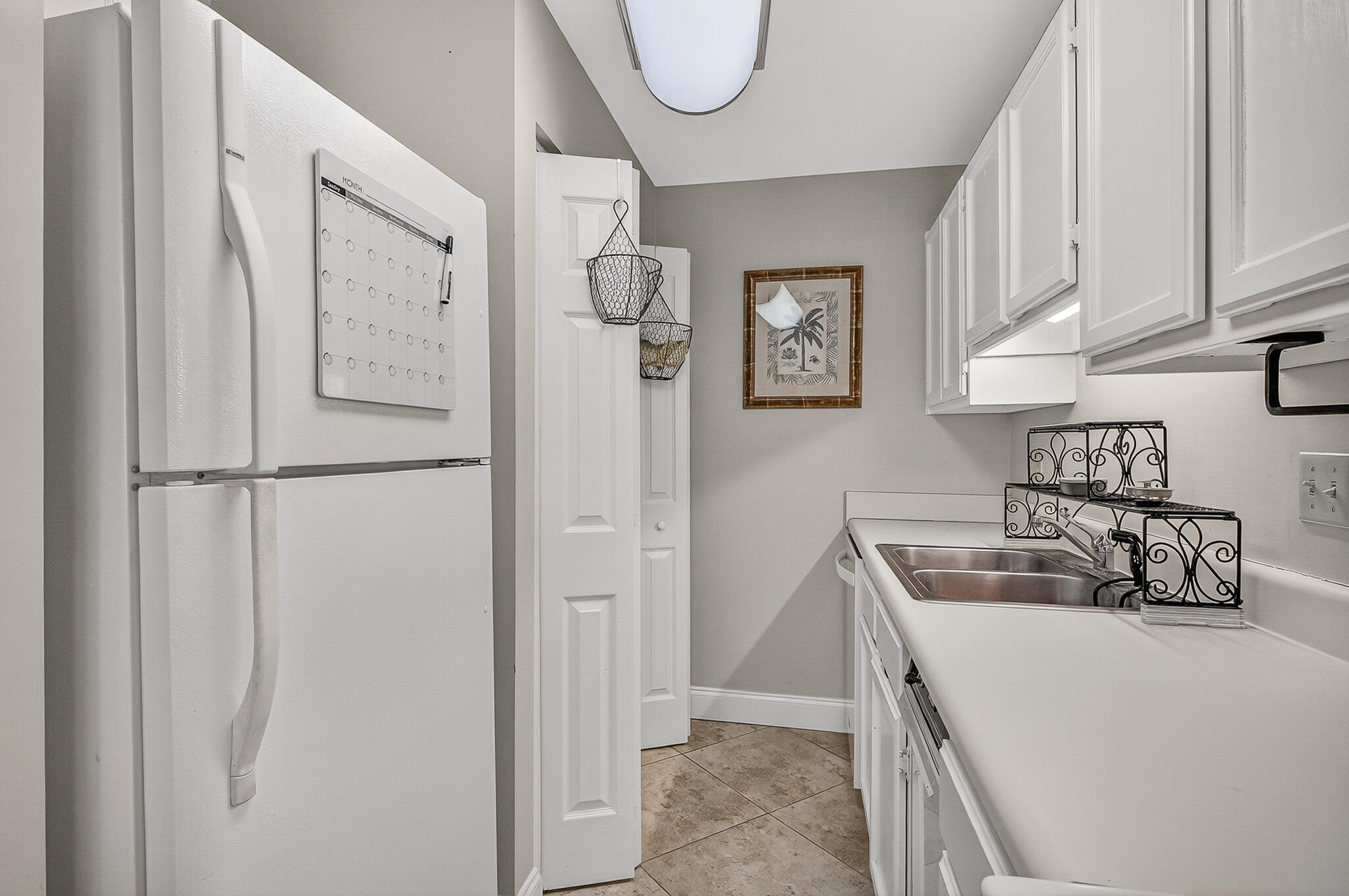 195 Durango Road, Unit 2D Destin, FL 32541 - Photo 24 of 62 a kitchen with a refrigerator a sink and cabinets