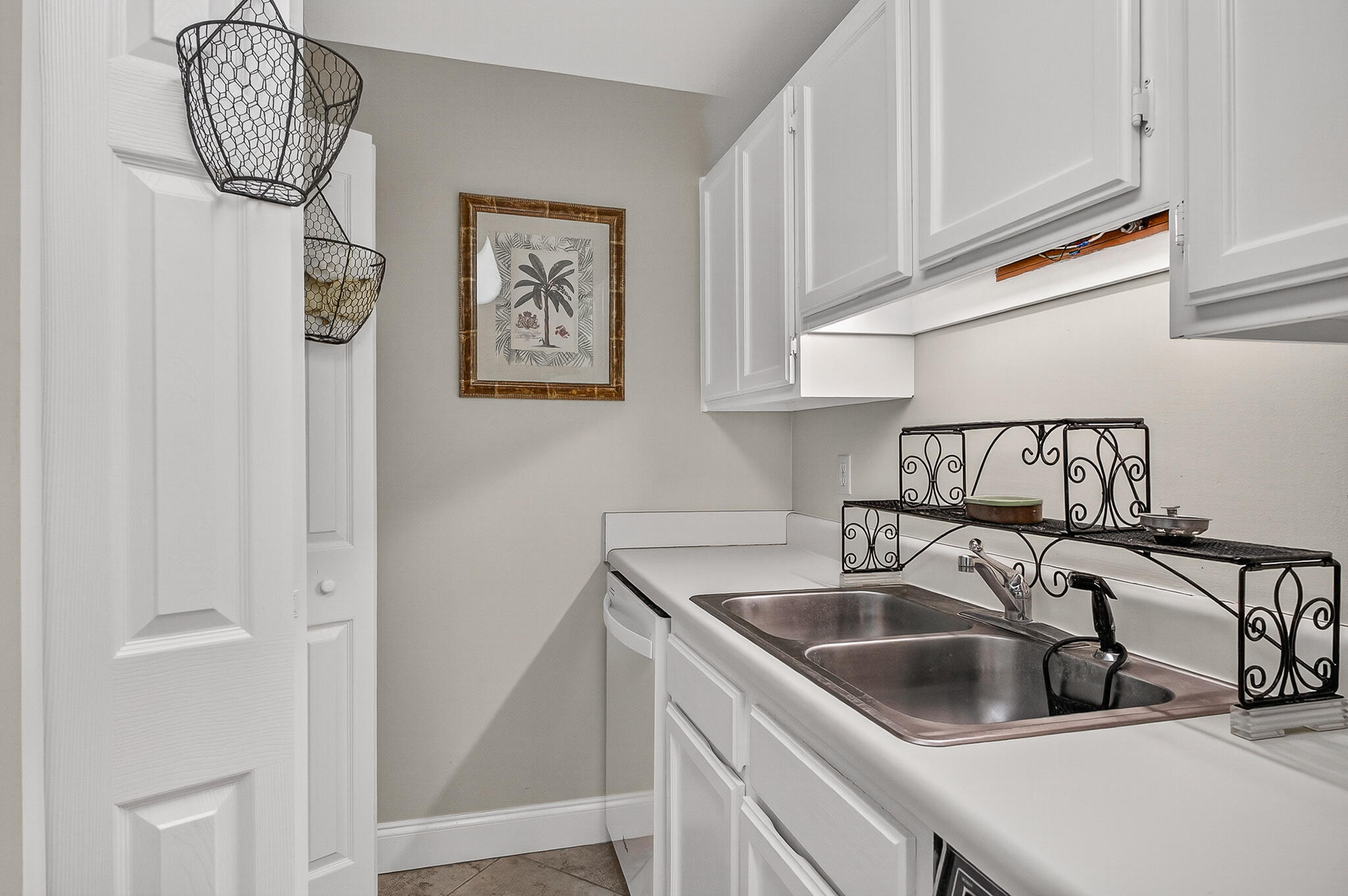 195 Durango Road, Unit 2D Destin, FL 32541 - Photo 25 of 62 a kitchen with stainless steel appliances granite countertop a sink a refrigerator and a white cabinets