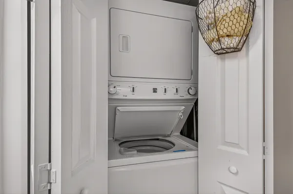 a living room with couches and a chandelier