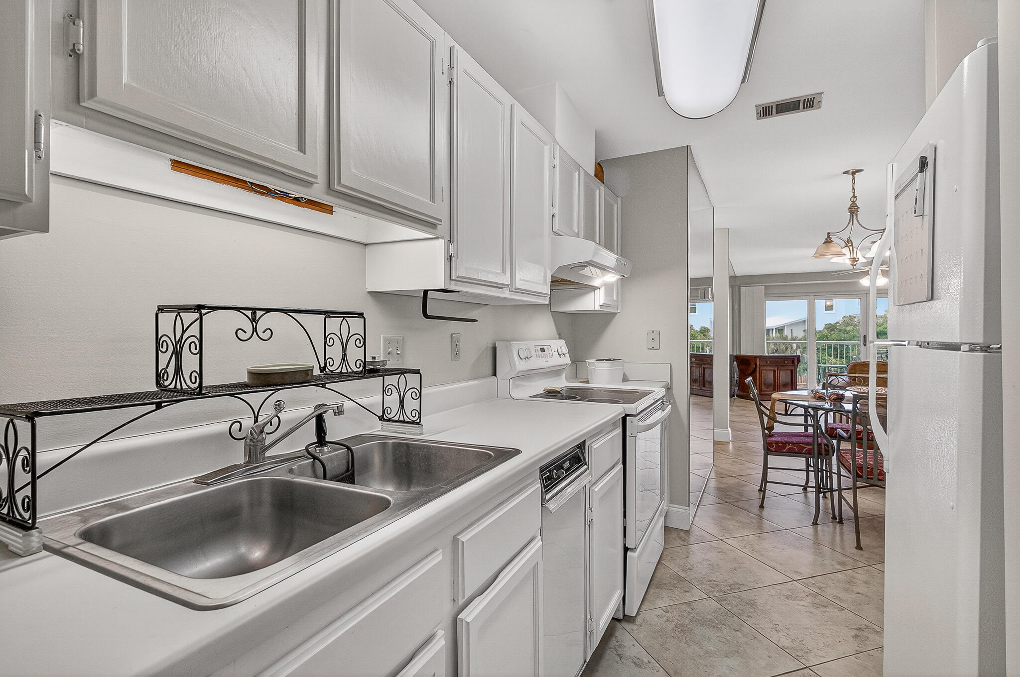 195 Durango Road, Unit 2D Destin, FL 32541 - Photo 27 of 62 a kitchen with a sink cabinets and appliances