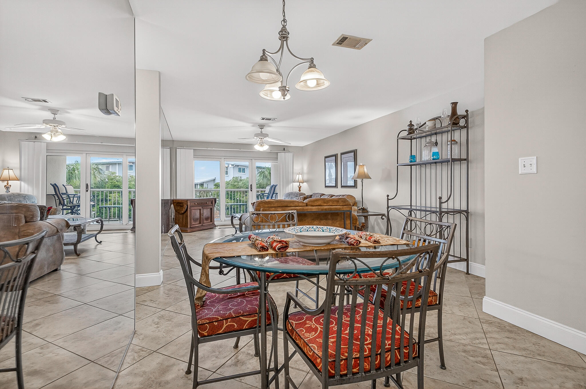 195 Durango Road, Unit 2D Destin, FL 32541 - Photo 30 of 62 a dining room with a wooden table and chairs