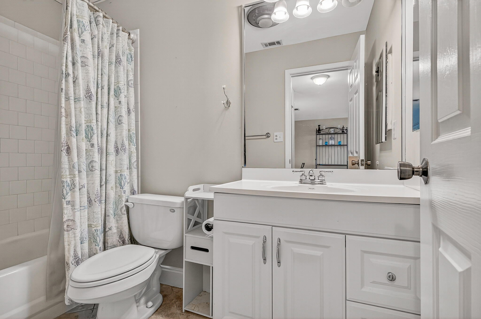 195 Durango Road, Unit 2D Destin, FL 32541 - Photo 40 of 62 a bathroom with a toilet sink and mirror