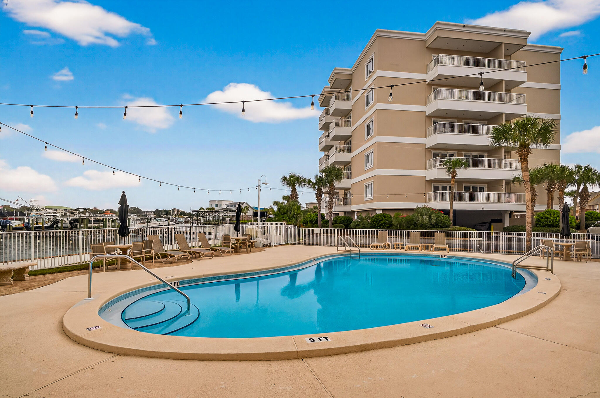 195 Durango Road, Unit 2D Destin, FL 32541 - Photo 7 of 62 a view of a swimming pool with a lounge chair