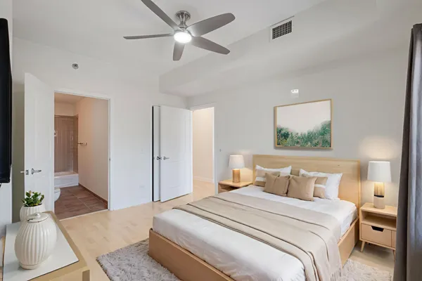 an empty room with closet and a ceiling fan