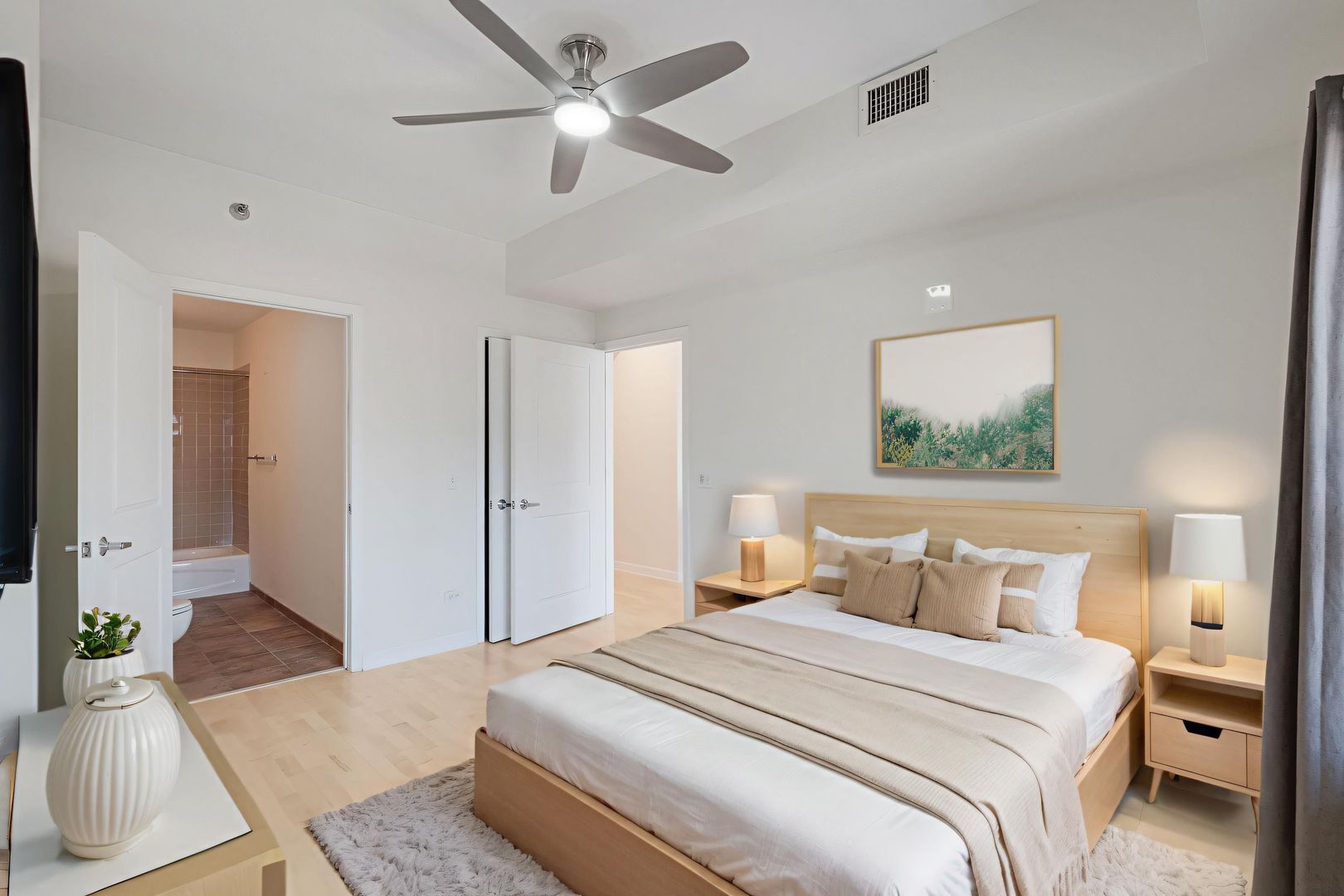 720 West Randolph Street, Unit 905 Chicago, IL 60661 - Photo 15 of 30 a bedroom with a large bed and a chandelier