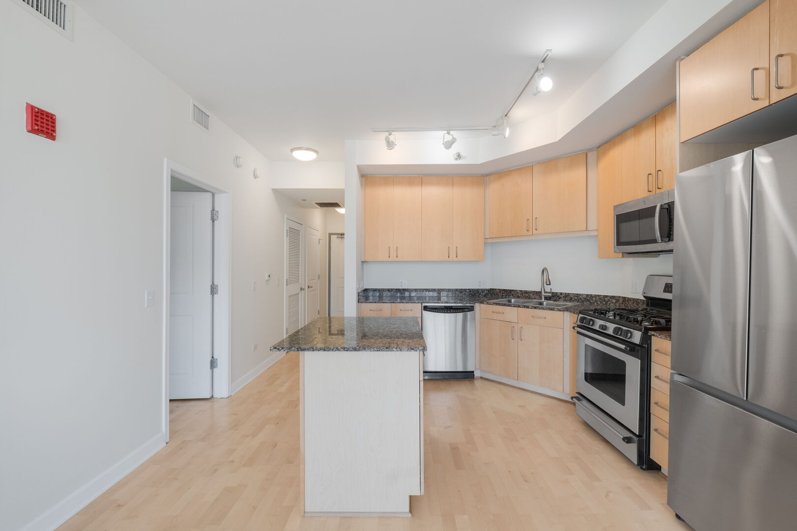720 West Randolph Street, Unit 905 Chicago, IL 60661 - Photo 4 of 30 a kitchen with stainless steel appliances granite countertop a refrigerator sink and stove