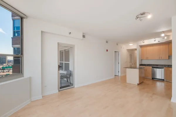 a kitchen with a stove and a living room