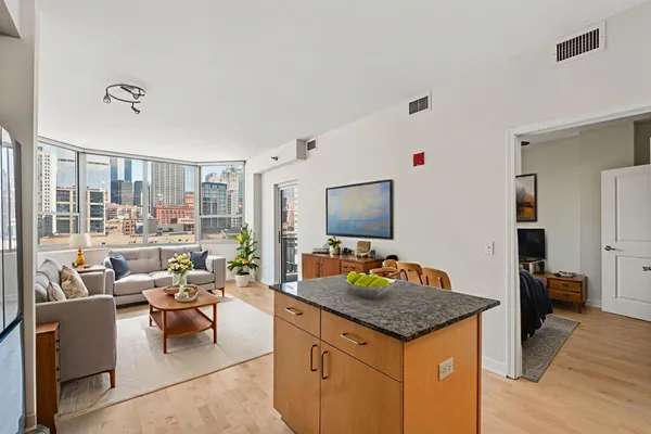 a living room with furniture and kitchen view