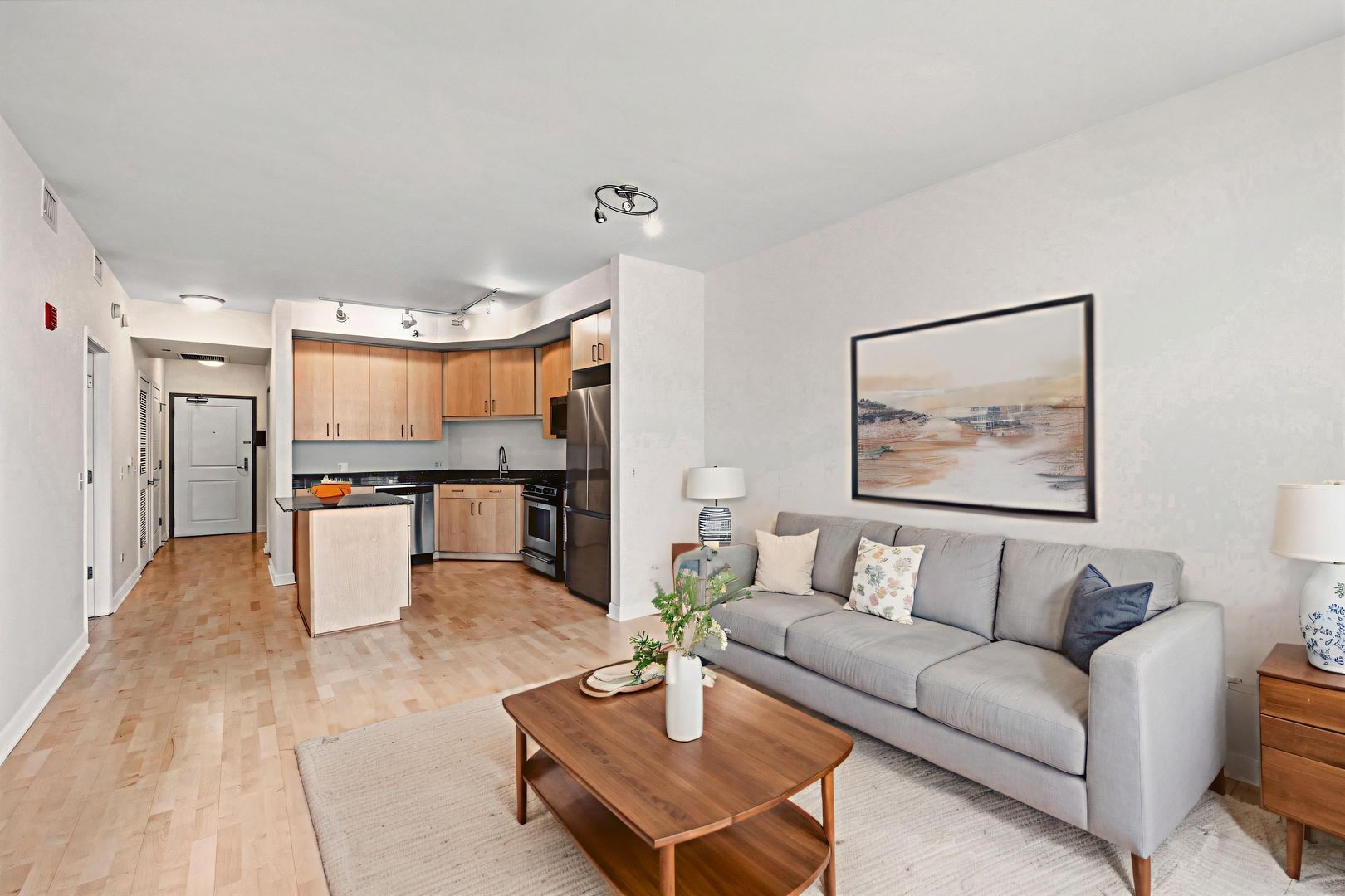 720 West Randolph Street, Unit 905 Chicago, IL 60661 - Photo 7 of 30 a living room with furniture and kitchen view