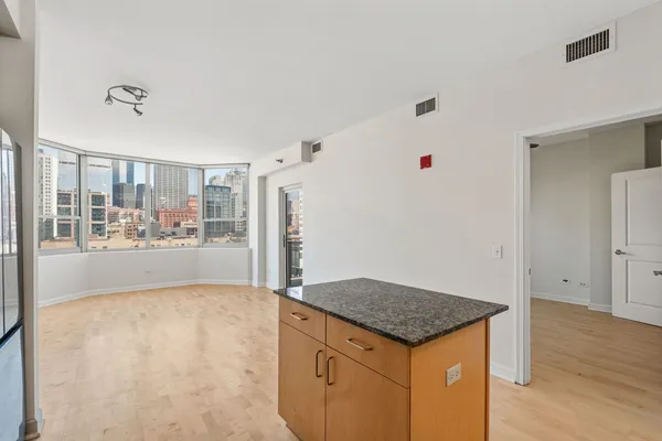 a view of kitchen with stainless steel appliances cabinets and wooden floor