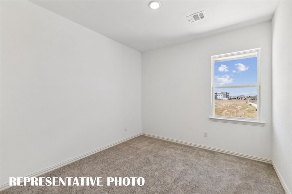 1027 Splitrock Drive Allen, TX 75013 - Photo 12 of 18 an empty room with a wooden door
